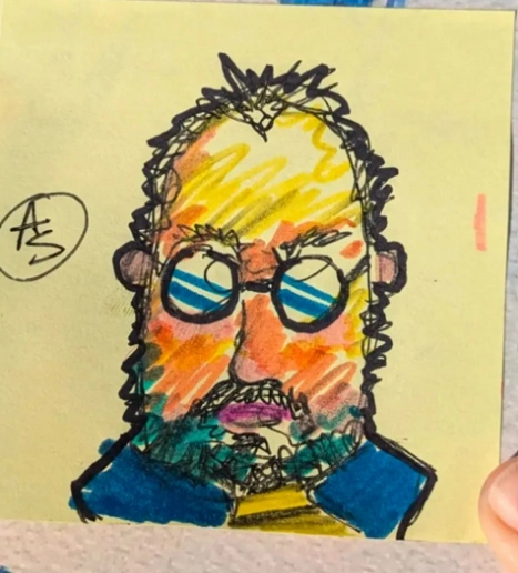 A post-it note sketch of a man with glasses and a beard.